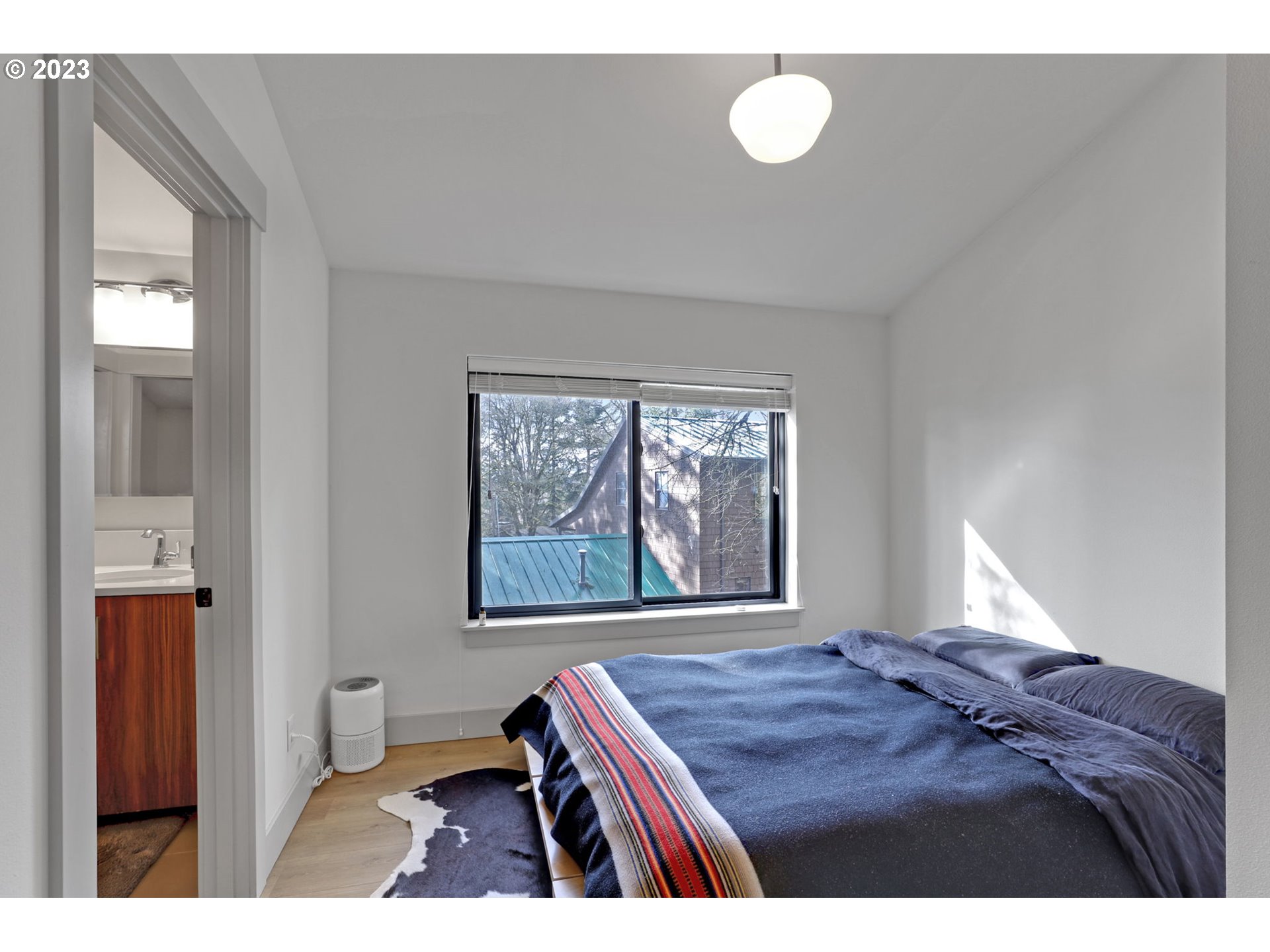 12434 Southwest 57th Avenue Portland, OR 97219 - Photo 30 of 34 a bedroom with a bed and window