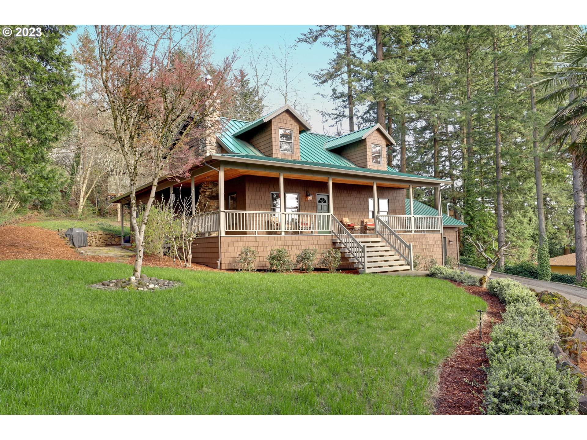 12434 Southwest 57th Avenue Portland, OR 97219 - Photo 6 of 34 a front view of a house with a yard