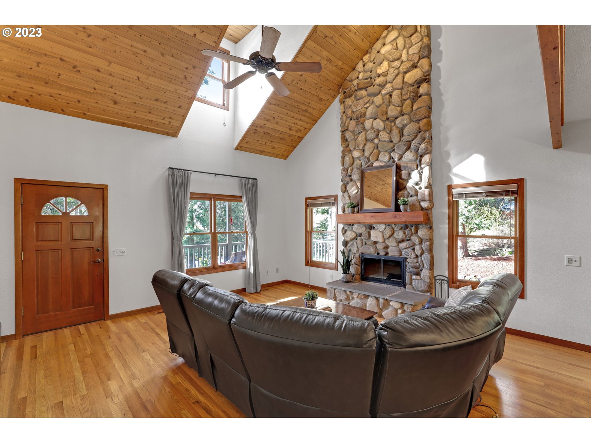 12434 Southwest 57th Avenue Portland, OR 97219 - Photo 8 of 34 a living room with furniture and a fireplace