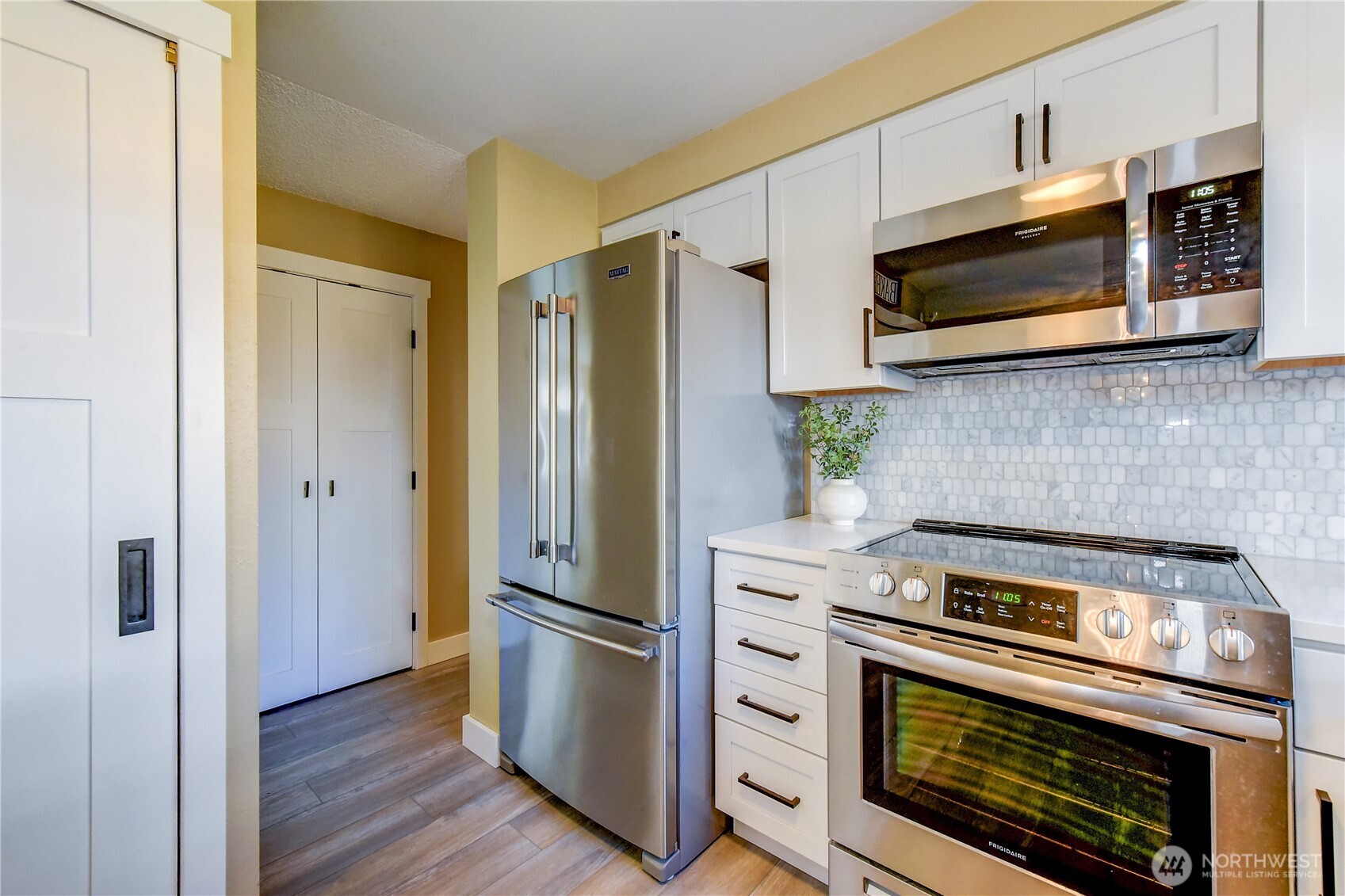 525 218th Street Southwest Bothell, WA 98021 - Photo 13 of 30 a kitchen with stainless steel appliances a stove a microwave and cabinets