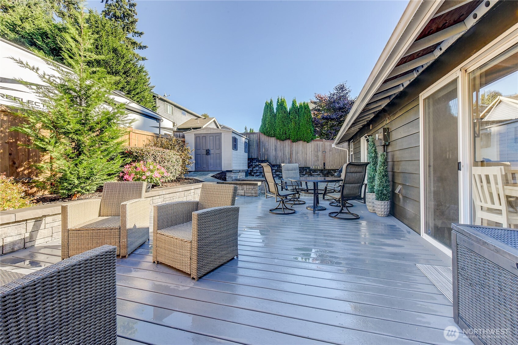525 218th Street Southwest Bothell, WA 98021 - Photo 14 of 30 a view of a patio with table and chairs potted plants and floor to ceiling window