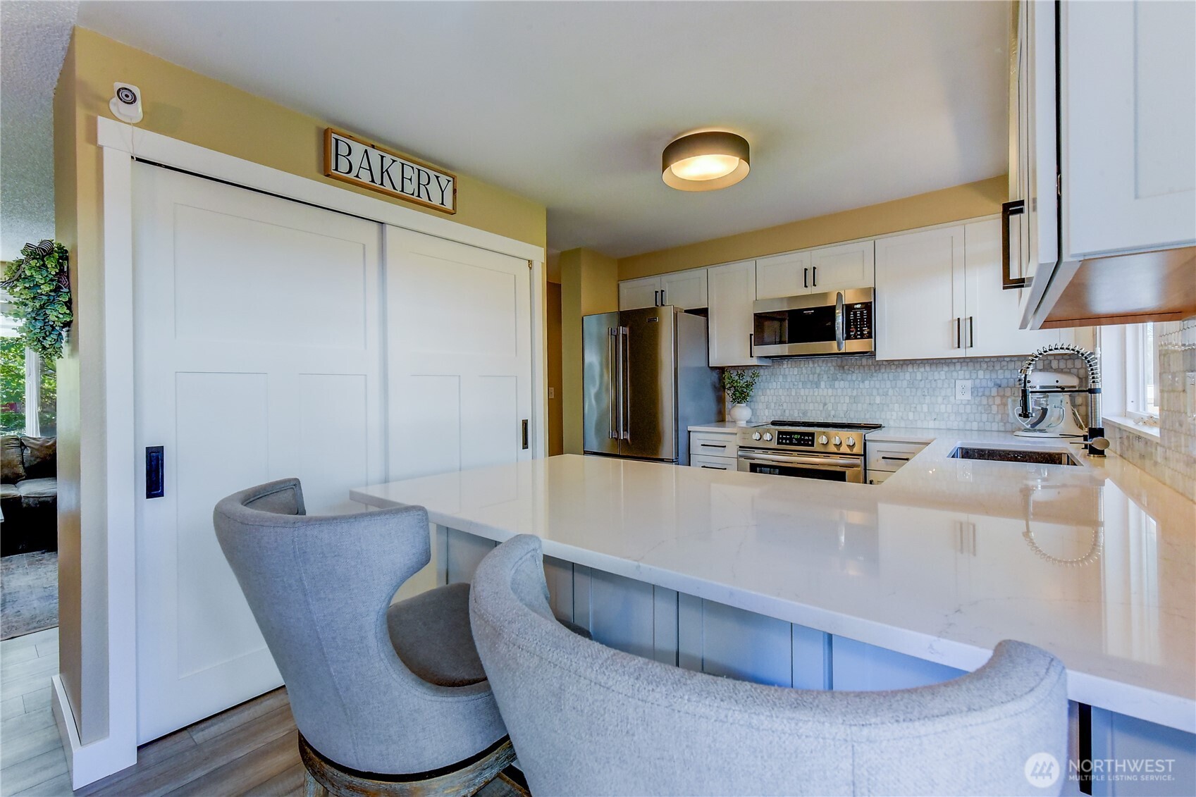 525 218th Street Southwest Bothell, WA 98021 - Photo 10 of 30 a kitchen with stainless steel appliances granite countertop a sink a stove and a refrigerator