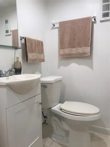 a white toilet sitting next to a bathroom sink