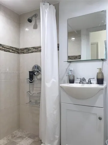 a bathroom with a sink and shower