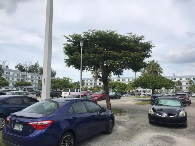 a view of cars parked on the side of a street