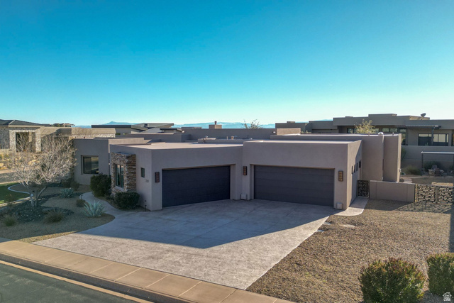 2197 Reserve Circle St. George, UT 84770 - Photo 50 of 57 Pueblo-style house with stucco siding, a garage, driveway, and a residential view