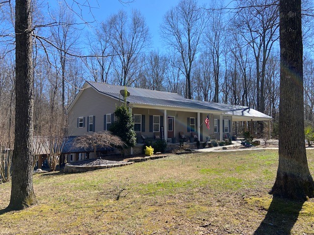 142 Lockmiller Road Winchester, TN 37398 - Photo 3 of 44 a front view of a house with a yard outdoor seating and covered with trees