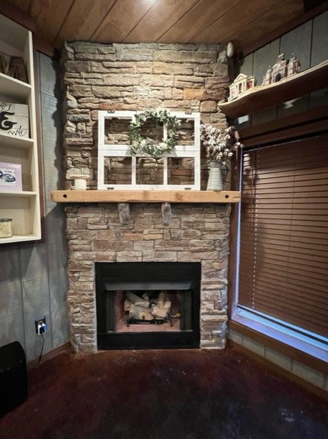 142 Lockmiller Road Winchester, TN 37398 - Photo 37 of 44 a living room with a fireplace a rug and a window