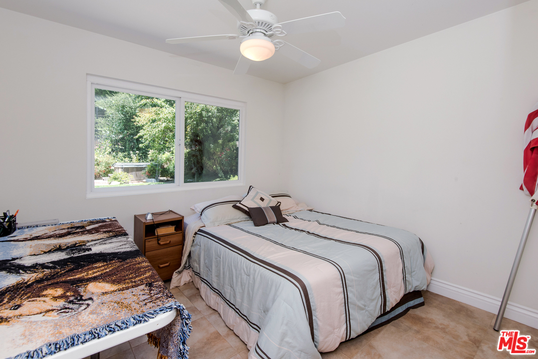 5533 Jon Dodson Drive Agoura Hills, CA 91301 - Photo 11 of 23 a bedroom with a bed and a window