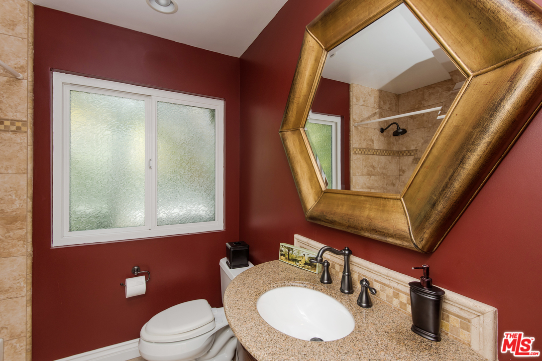 5533 Jon Dodson Drive Agoura Hills, CA 91301 - Photo 12 of 23 a bathroom with a sink vanity mirror and toilet