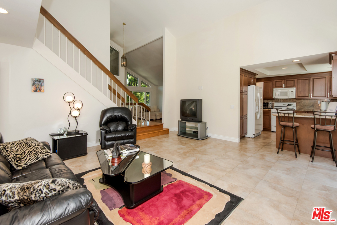5533 Jon Dodson Drive Agoura Hills, CA 91301 - Photo 16 of 23 a living room with furniture and a flat screen tv