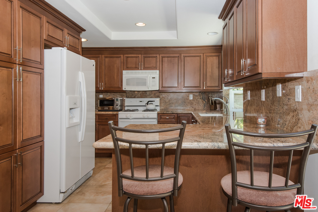 5533 Jon Dodson Drive Agoura Hills, CA 91301 - Photo 3 of 23 a kitchen with stainless steel appliances a refrigerator and a stove