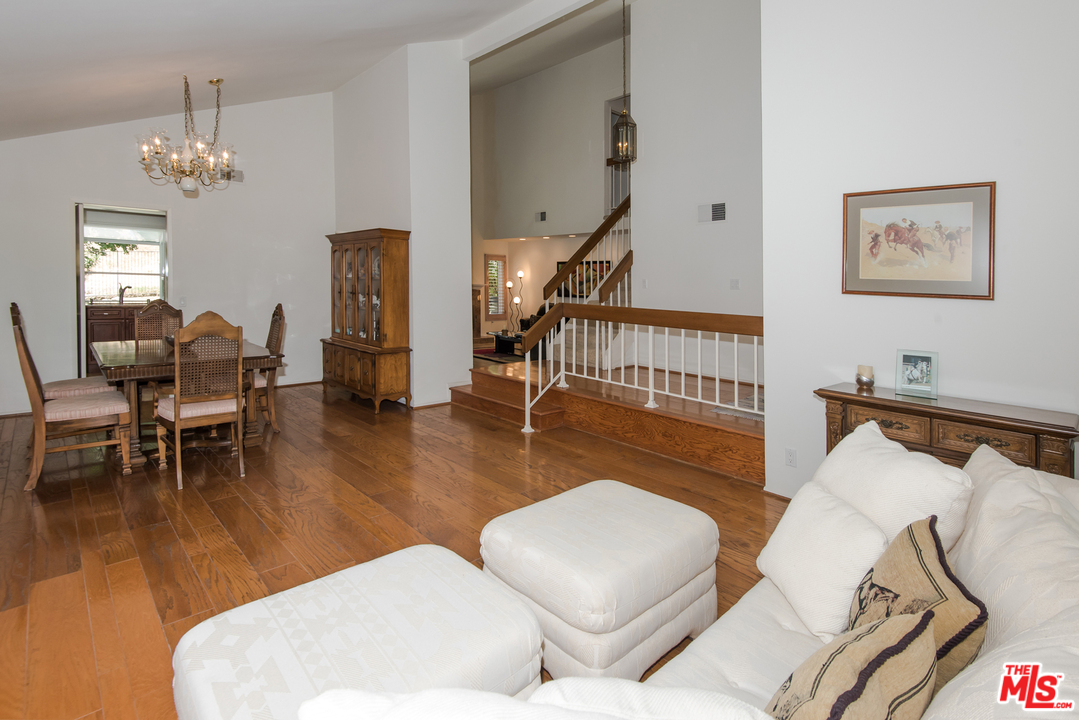 5533 Jon Dodson Drive Agoura Hills, CA 91301 - Photo 21 of 23 a living room with furniture chandelier and a wooden floor