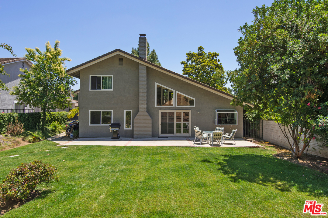 5533 Jon Dodson Drive Agoura Hills, CA 91301 - Photo 22 of 23 a front view of house with a garden and trees