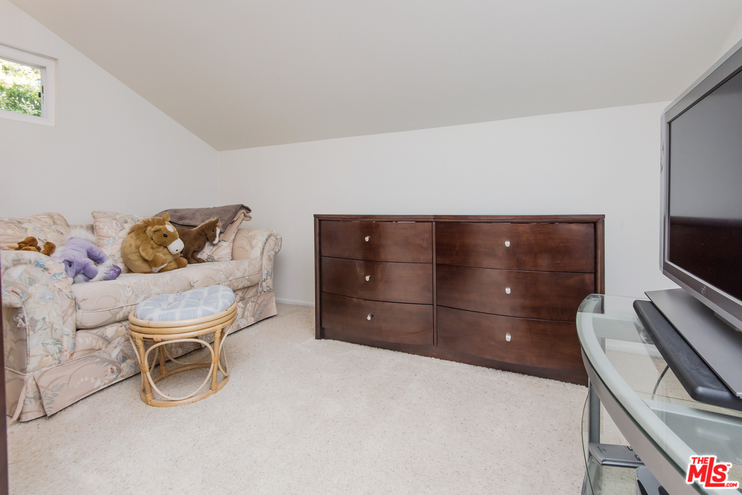 5533 Jon Dodson Drive Agoura Hills, CA 91301 - Photo 8 of 23 a room with a dresser and a chair