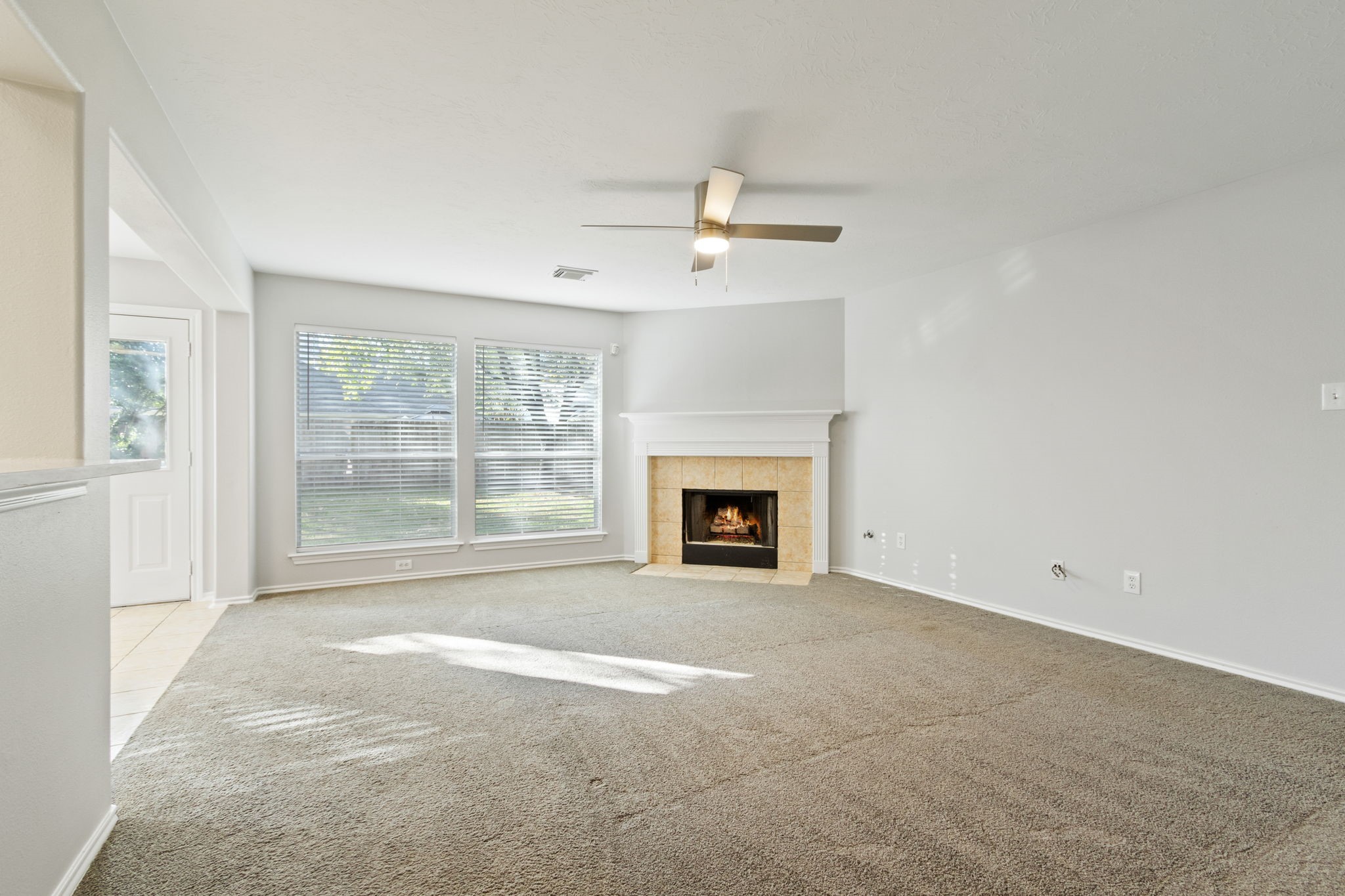 21035 Summer Trace Lane Spring, TX 77379 - Photo 11 of 50 a view of an empty room with a fireplace and a window
