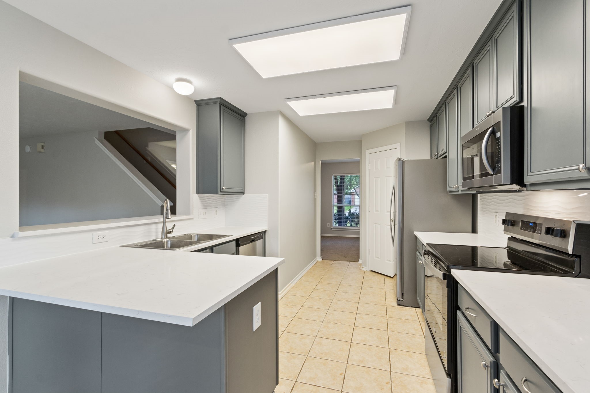 21035 Summer Trace Lane Spring, TX 77379 - Photo 14 of 50 a kitchen with stainless steel appliances a sink stove and cabinets