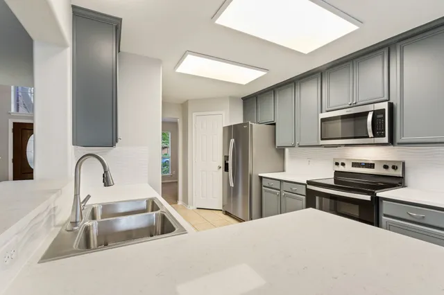 a kitchen with a sink stove and microwave