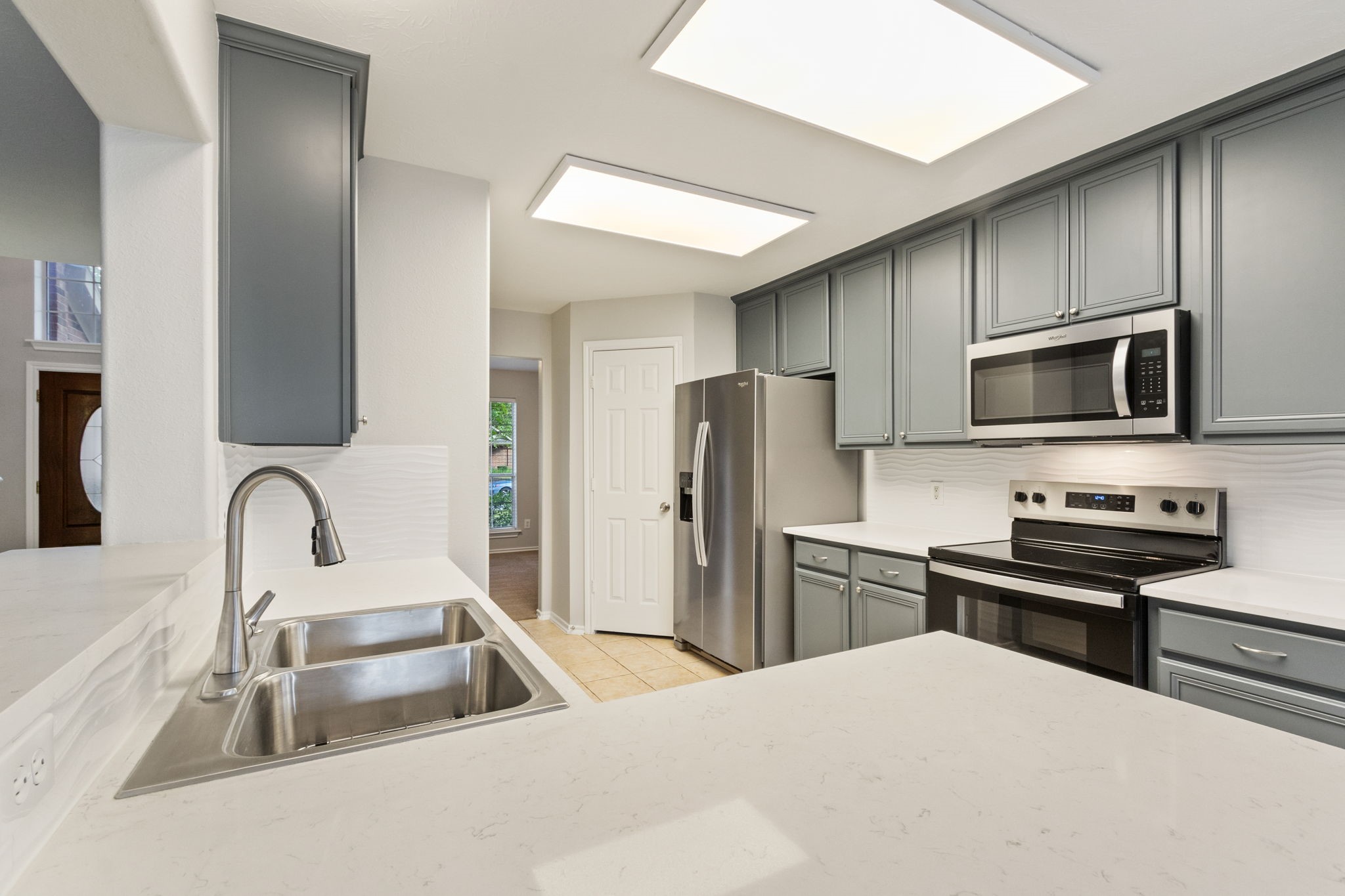 21035 Summer Trace Lane Spring, TX 77379 - Photo 15 of 50 a kitchen with a refrigerator a sink a stove and cabinets