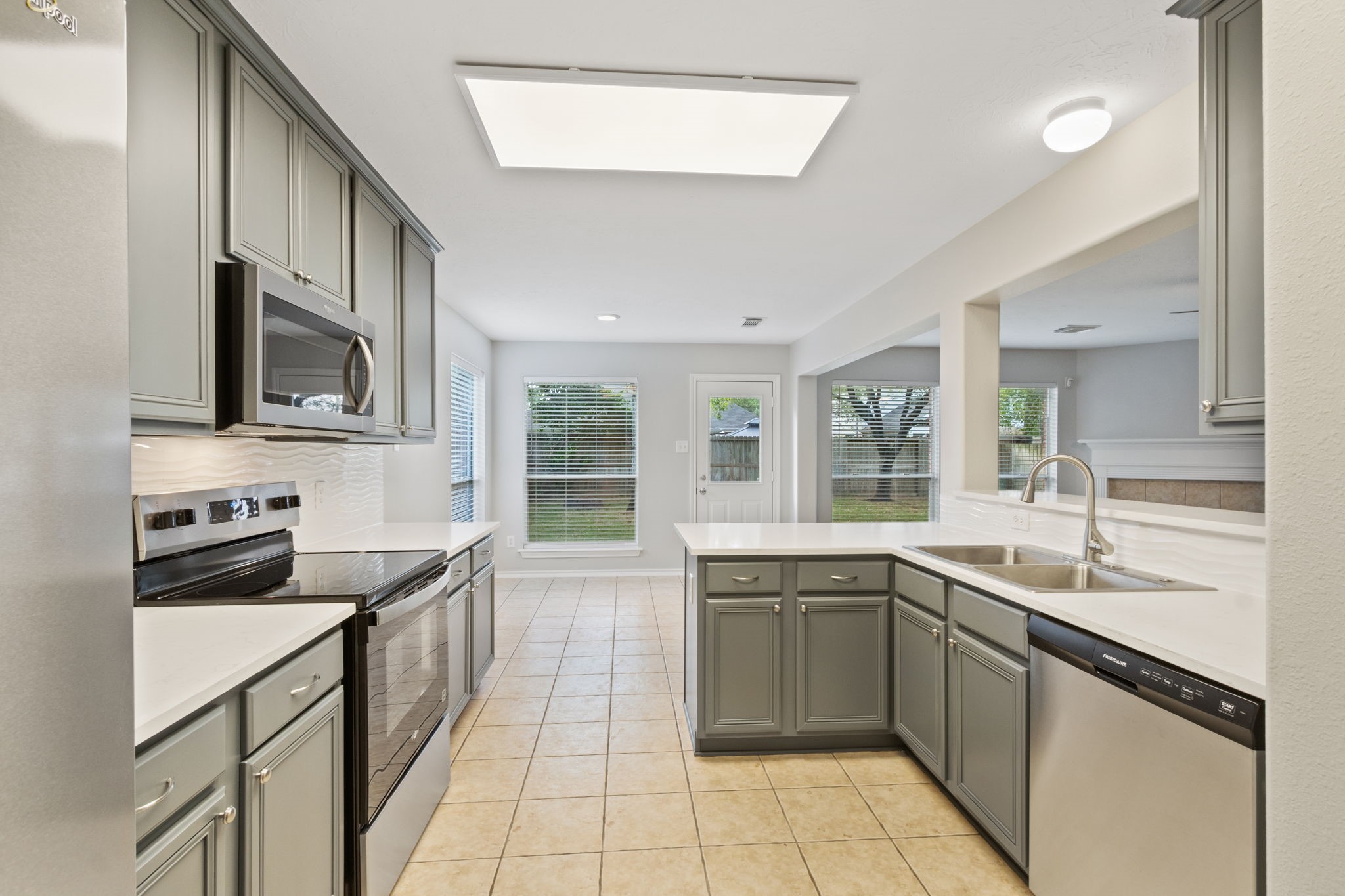 21035 Summer Trace Lane Spring, TX 77379 - Photo 16 of 50 a kitchen with a sink stove and microwave