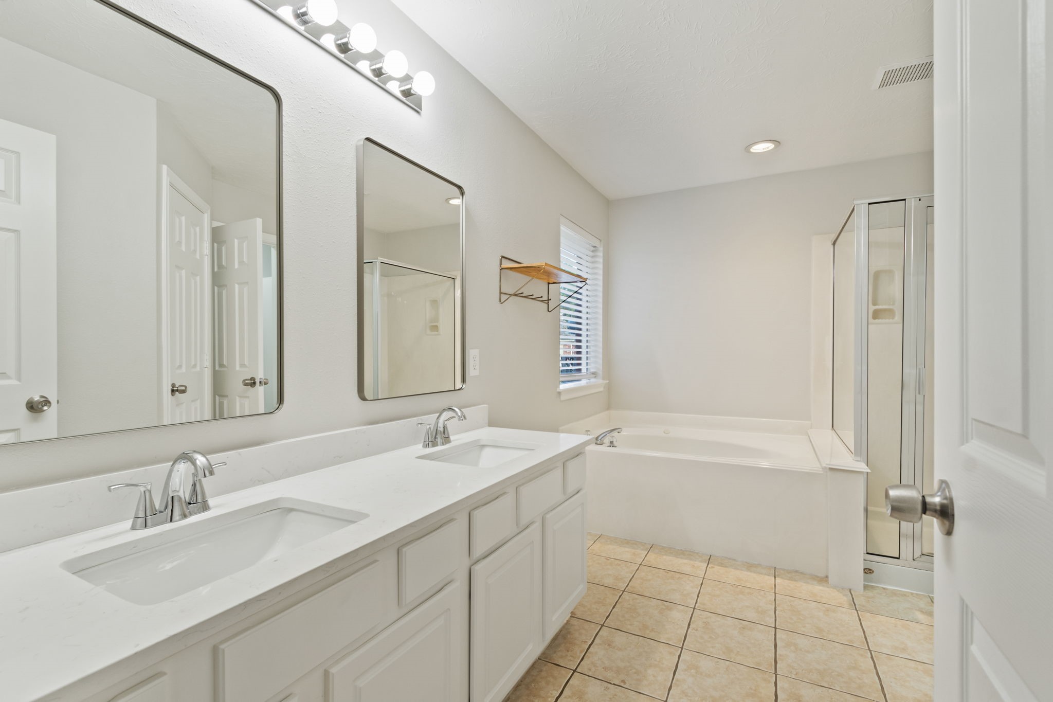 21035 Summer Trace Lane Spring, TX 77379 - Photo 21 of 50 a bathroom with a sink double vanity granite tub shower and a mirror