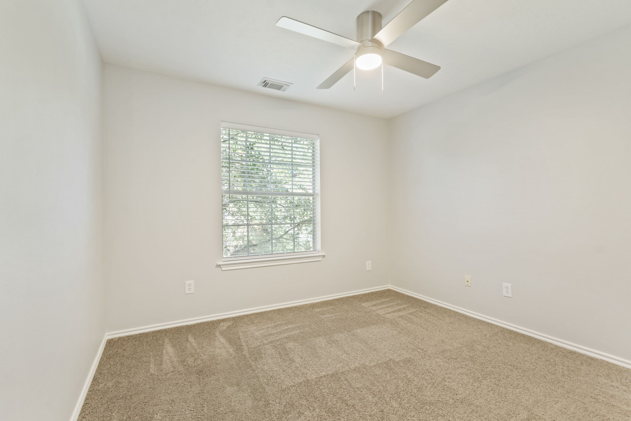 21035 Summer Trace Lane Spring, TX 77379 - Photo 27 of 50 an empty room with a window and a fan