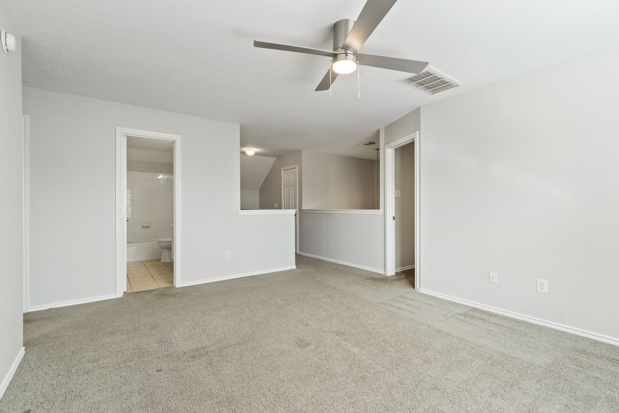 21035 Summer Trace Lane Spring, TX 77379 - Photo 30 of 50 an empty room with a ceiling fan and carpet