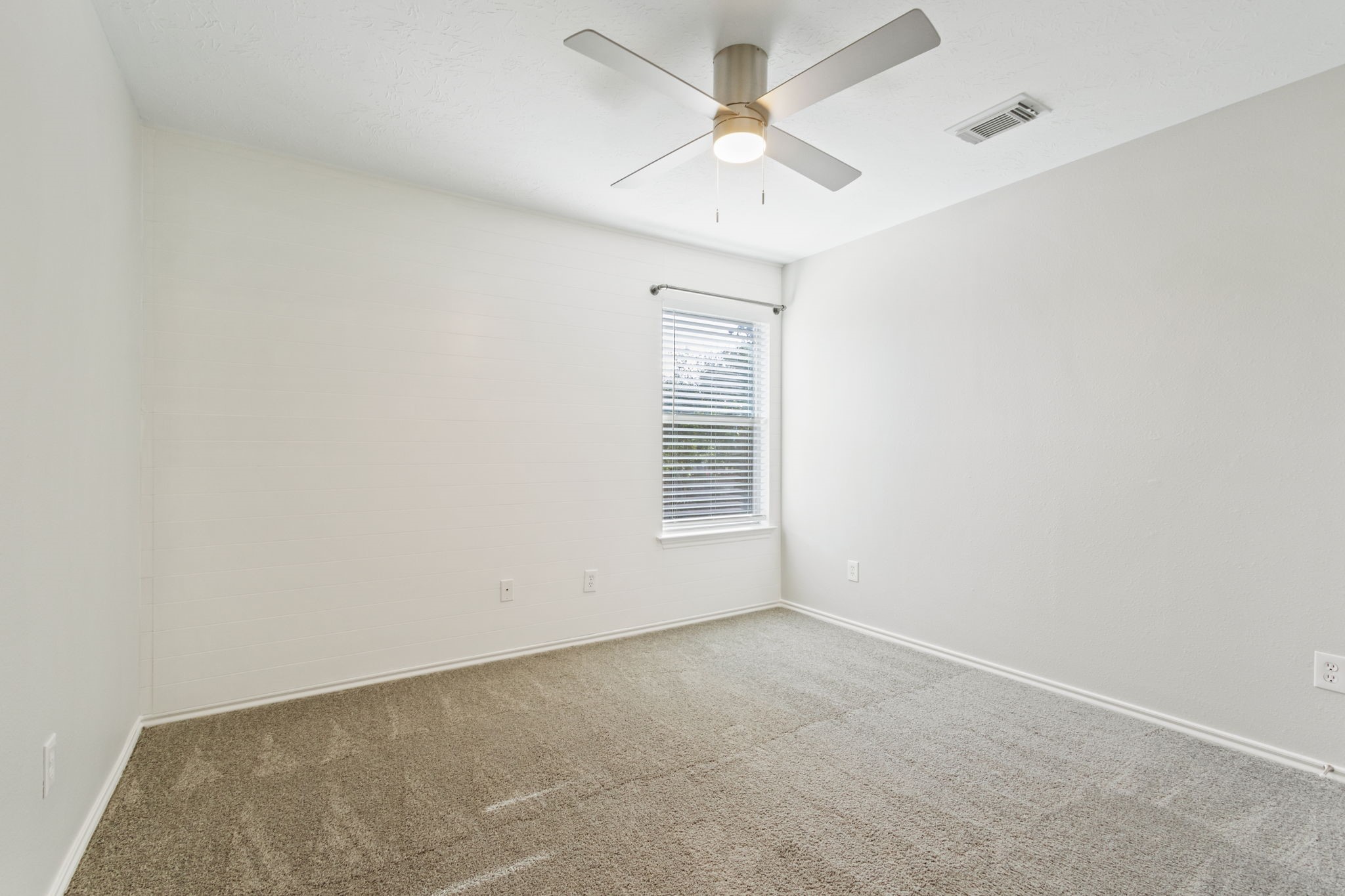 21035 Summer Trace Lane Spring, TX 77379 - Photo 34 of 50 an empty room with a chandelier fan and windows