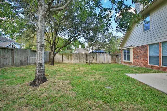 a view of a house with a backyard