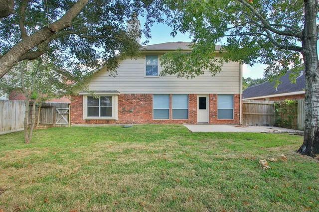 a house with a tree in the grass