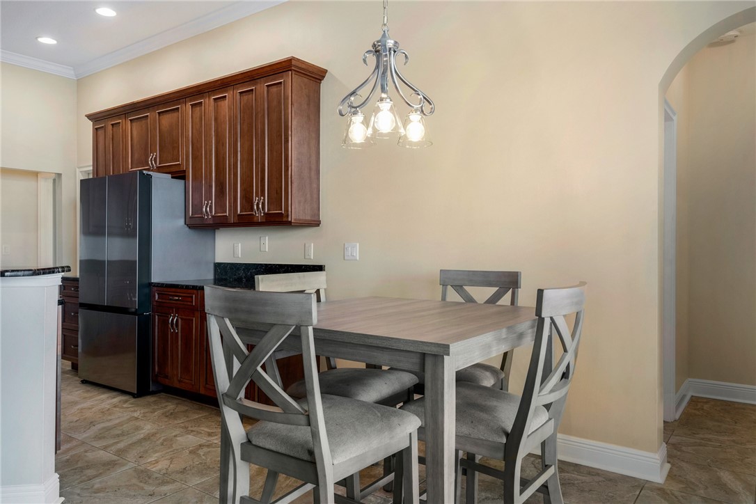 7635 Agawam Road Micco, FL 32976 - Photo 11 of 36 a kitchen with a table chairs refrigerator and microwave