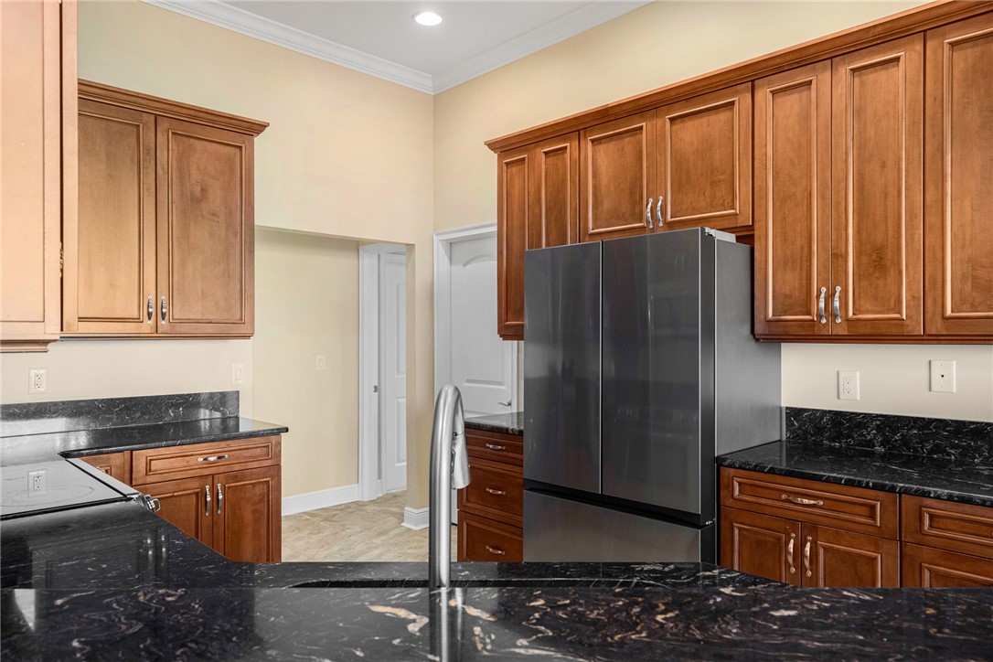 7635 Agawam Road Micco, FL 32976 - Photo 13 of 36 a kitchen with stainless steel appliances granite countertop a refrigerator and a stove top oven