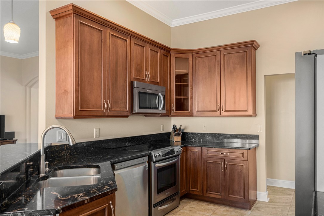 7635 Agawam Road Micco, FL 32976 - Photo 15 of 36 a kitchen with stainless steel appliances granite countertop a stove a sink and a microwave