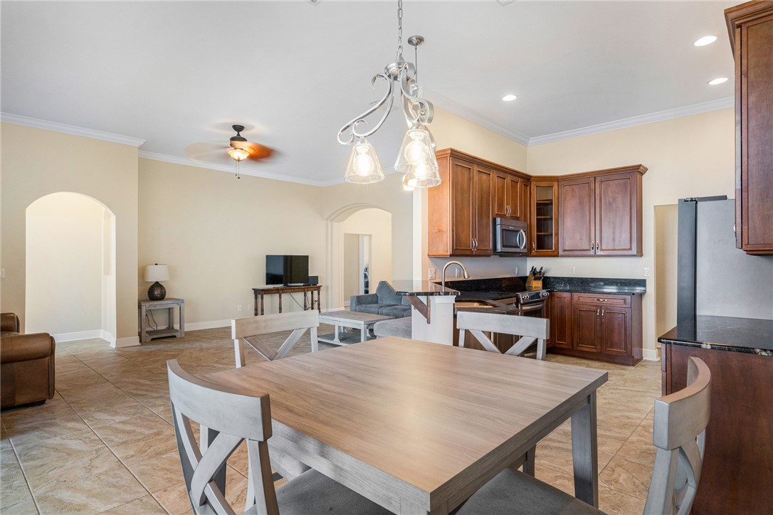 7635 Agawam Road Micco, FL 32976 - Photo 18 of 36 a large kitchen with a table and chairs