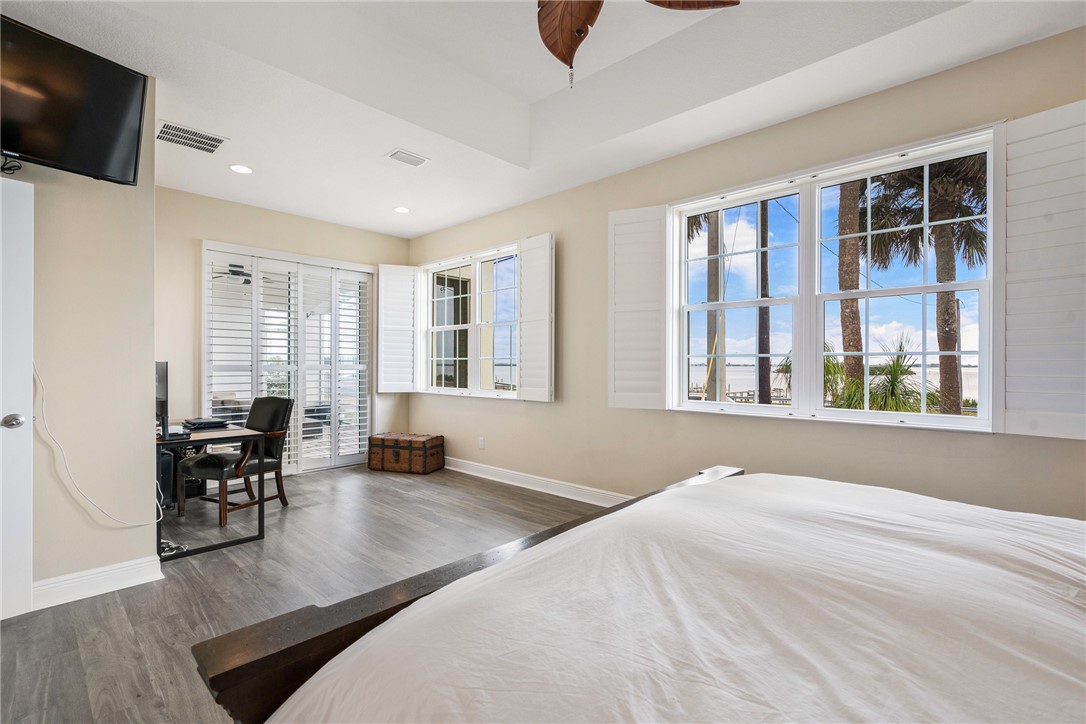 7635 Agawam Road Micco, FL 32976 - Photo 20 of 36 a bedroom with furniture and large windows