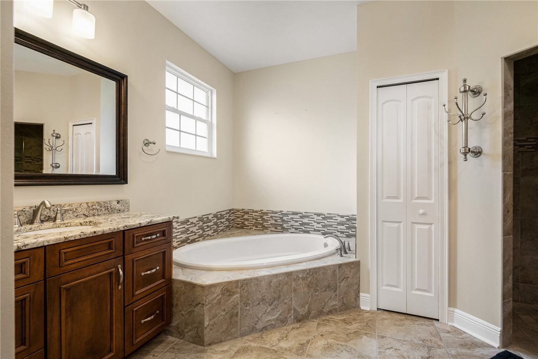 7635 Agawam Road Micco, FL 32976 - Photo 22 of 36 a bathroom with a granite countertop sink and a mirror