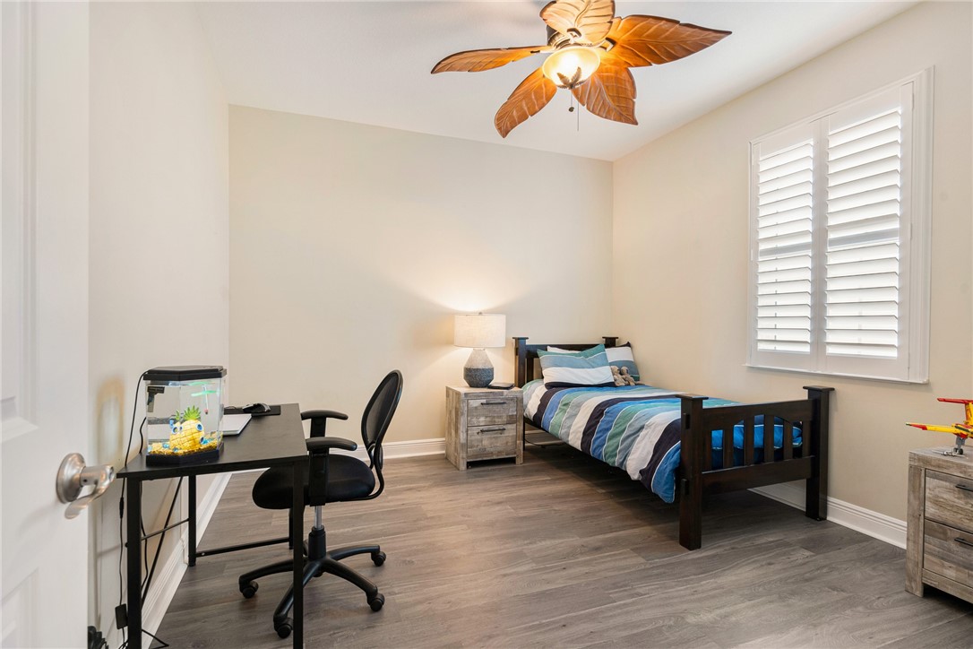 7635 Agawam Road Micco, FL 32976 - Photo 26 of 36 a bedroom with furniture and a window