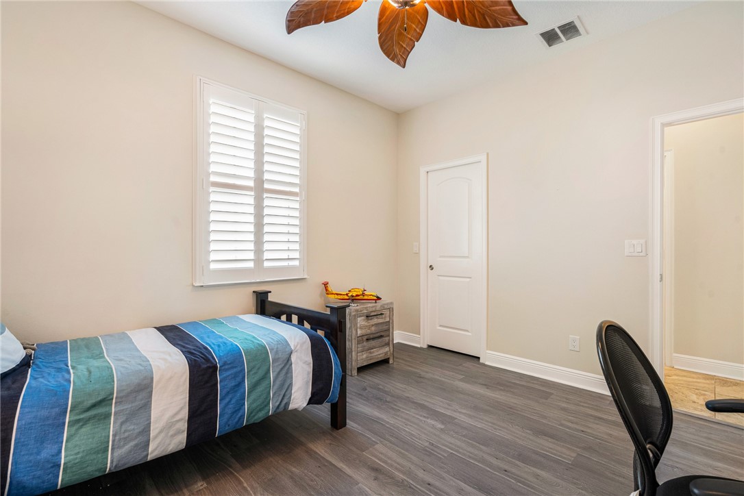 7635 Agawam Road Micco, FL 32976 - Photo 27 of 36 a bedroom with a bed and a window