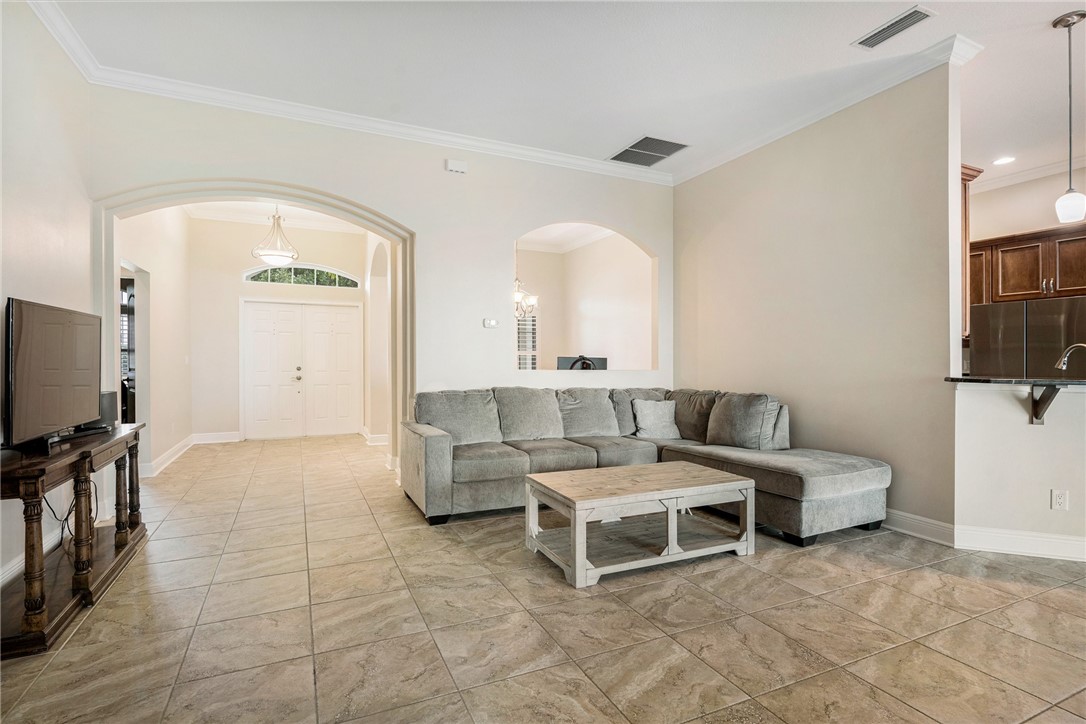 7635 Agawam Road Micco, FL 32976 - Photo 8 of 36 a living room with furniture and a flat screen tv