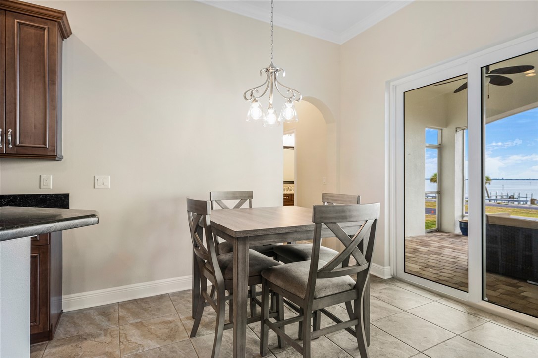 7635 Agawam Road Micco, FL 32976 - Photo 10 of 36 a view of a dining room with furniture and a chandelier