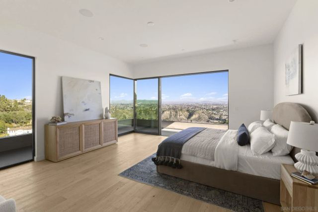 a bed room with a bed and a large window