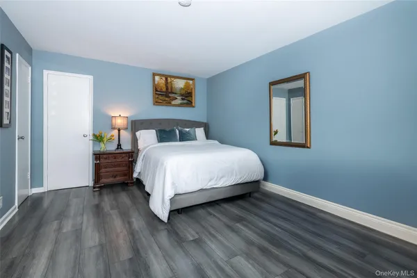 a bedroom with a bed table and a window