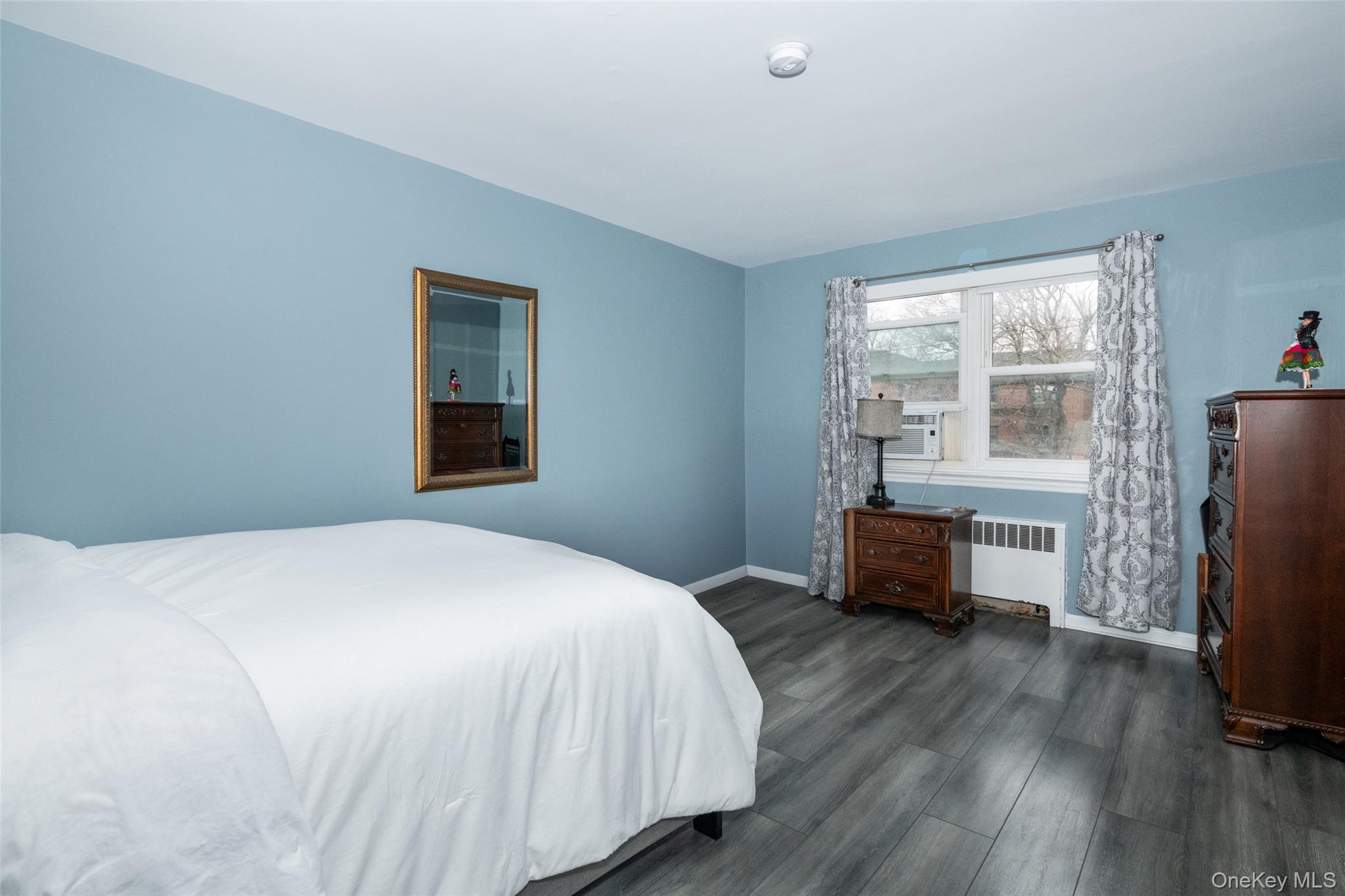 450 Pelham Road, Unit 3H New Rochelle, NY 10805 - Photo 15 of 16 a bedroom with a bed and wooden floor