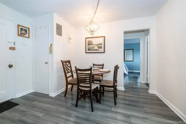a dining room with furniture and wooden floor
