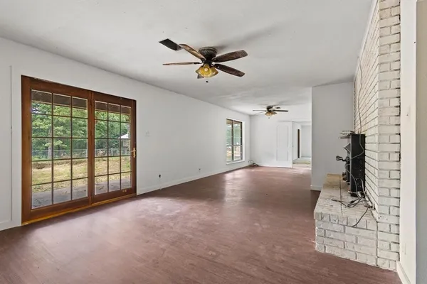 a view of a livingroom with a ceiling fan and window