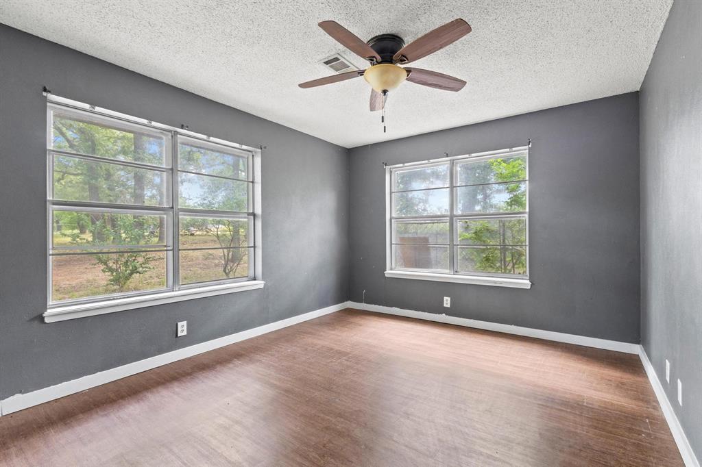 5994 Fm 1753 Denison, TX 75021 - Photo 22 of 34 an empty room with a window and a ceiling fan