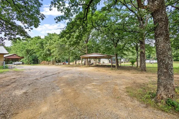 a view of a house with large trees