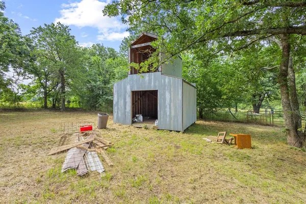 a backyard of a house with swimming pool and trees