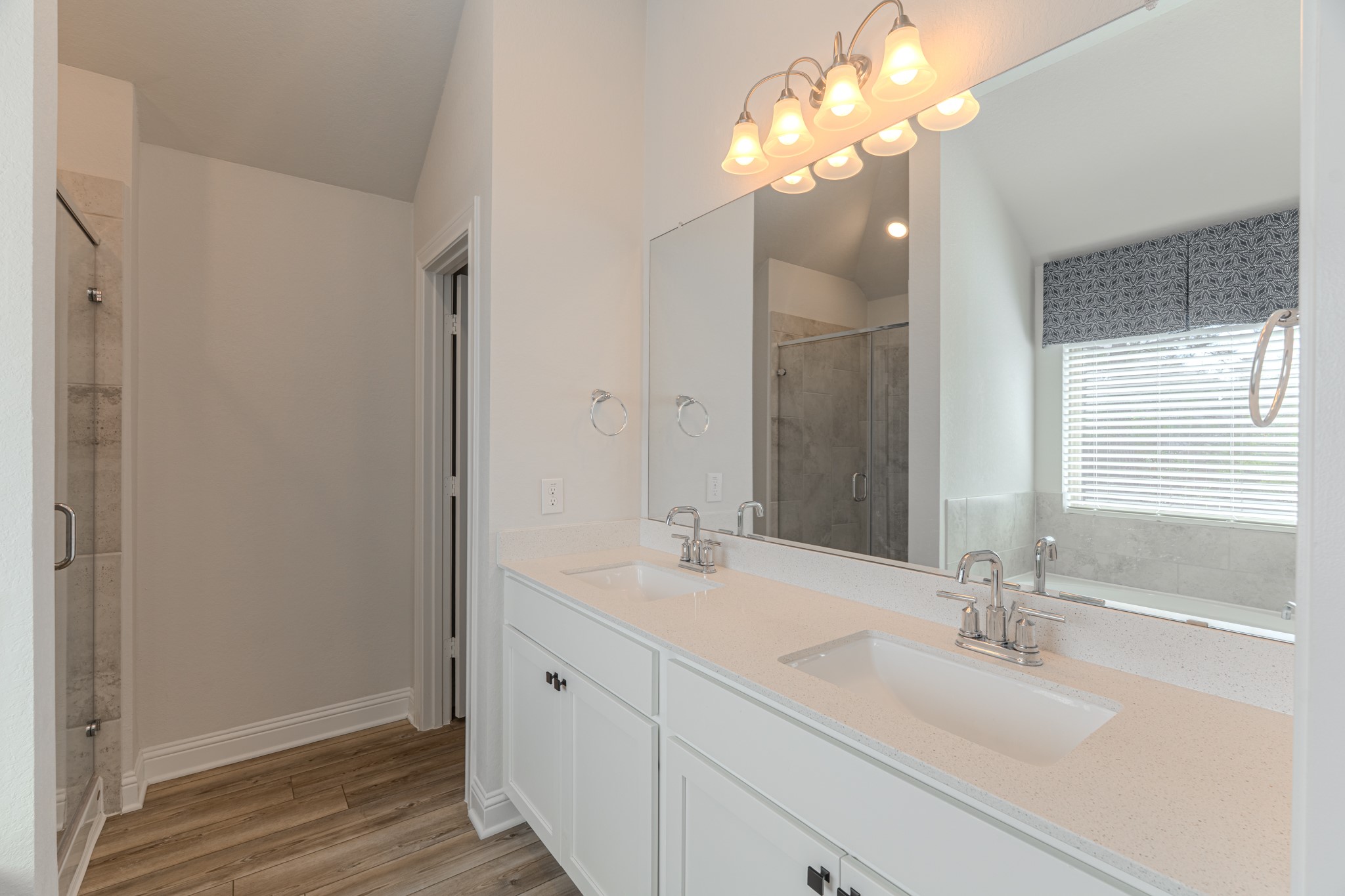 9840 Sweet Flag Court Conroe, TX 77385 - Photo 27 of 50 Spa-like primary bathroom features dual vanities, a soaking tub, separate shower, and a spacious walk-in closet designed for both comfort and convenience.