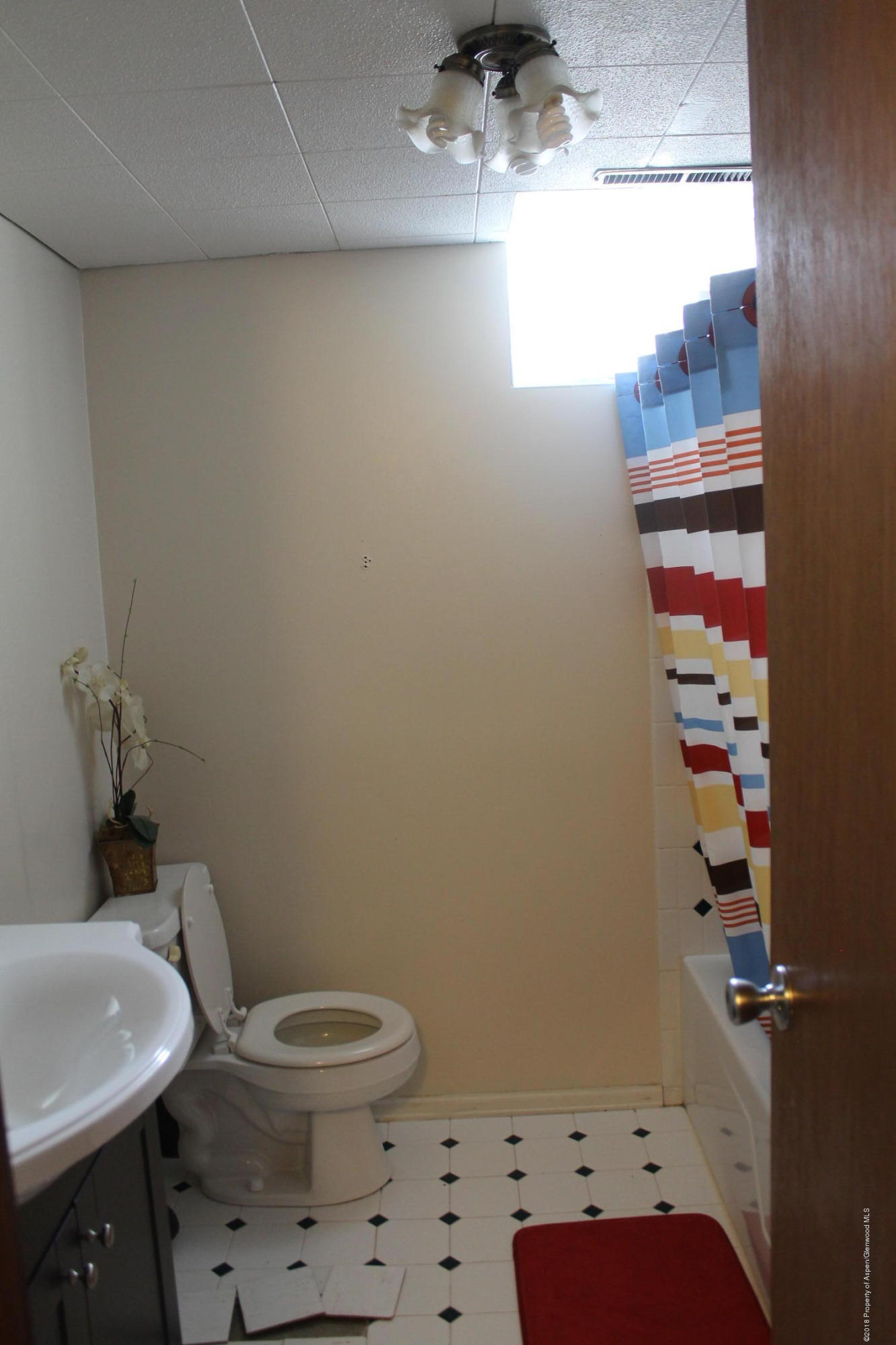 405 Ute Avenue Rifle, CO 81650 - Photo 14 of 21 a bathroom with a toilet a sink and a mirror